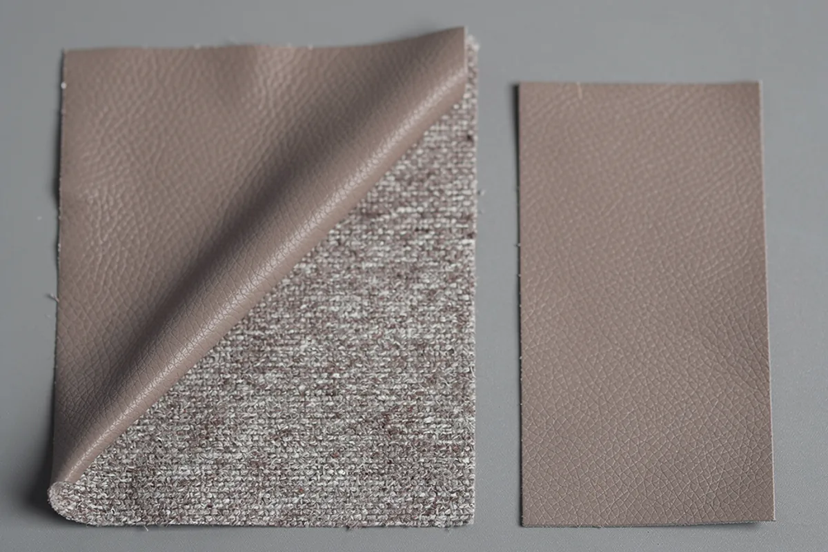 Taupe coated textile samples with one folded corner revealing a woven underside
