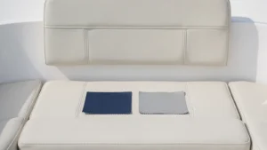Navy and grey material swatches on a cream upholstered boat seat