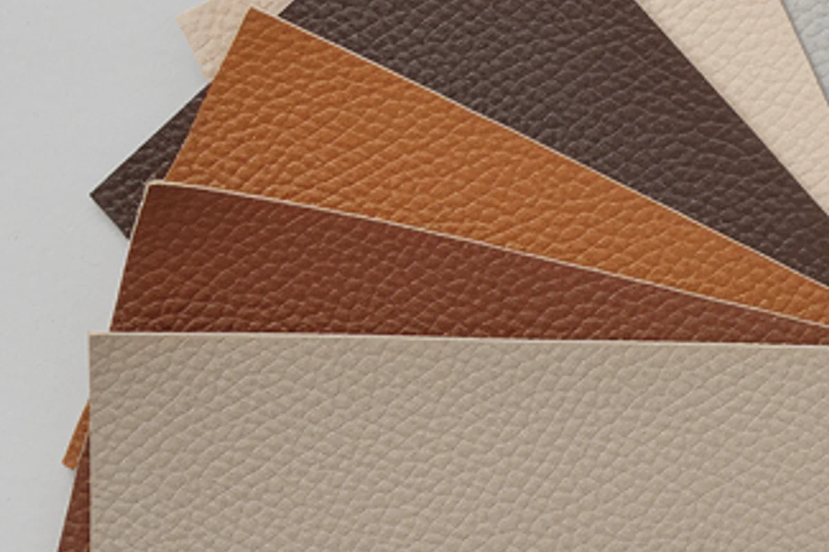 Overlapping cream, brown and tan leather-look swatches arranged for visual comparison