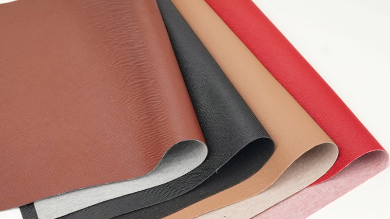 Tan leather-look sample rectangles with one folded corner showing a textile backing