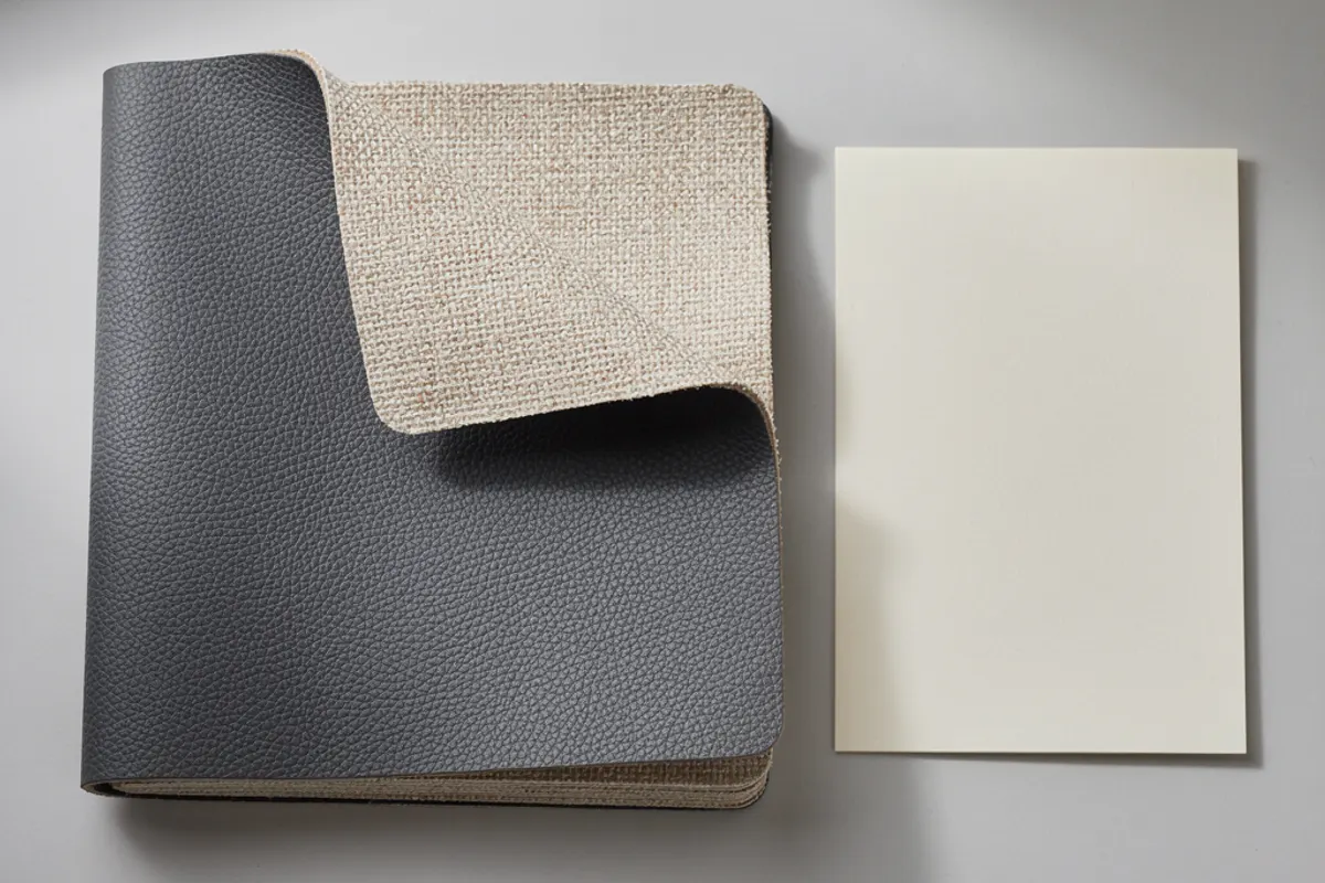 Dark textured swatches with a pale woven reverse beside a blank cream card