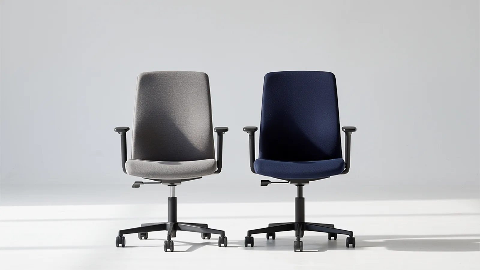 Two concept office chairs with matching shapes and contrasting coated and woven upholstery